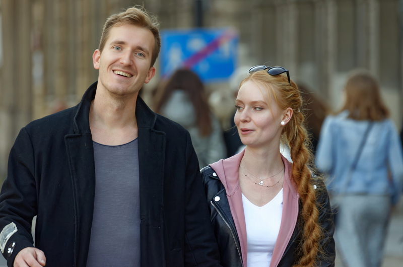25 - Two individuals walking closely together while talking